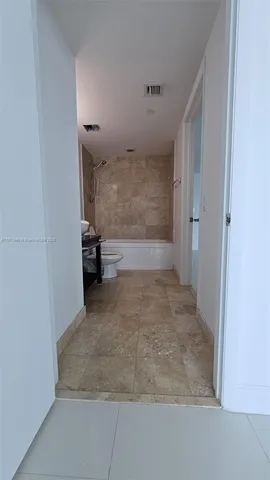 a view of cabinets and a refrigerator in a room