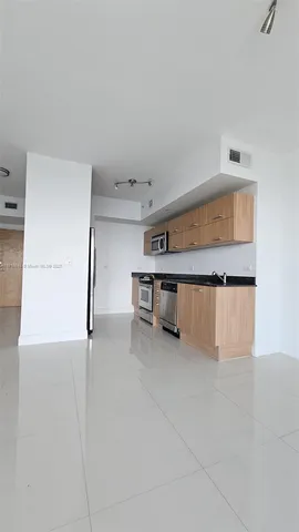 a view of a kitchen with a dishwasher and a refrigerator
