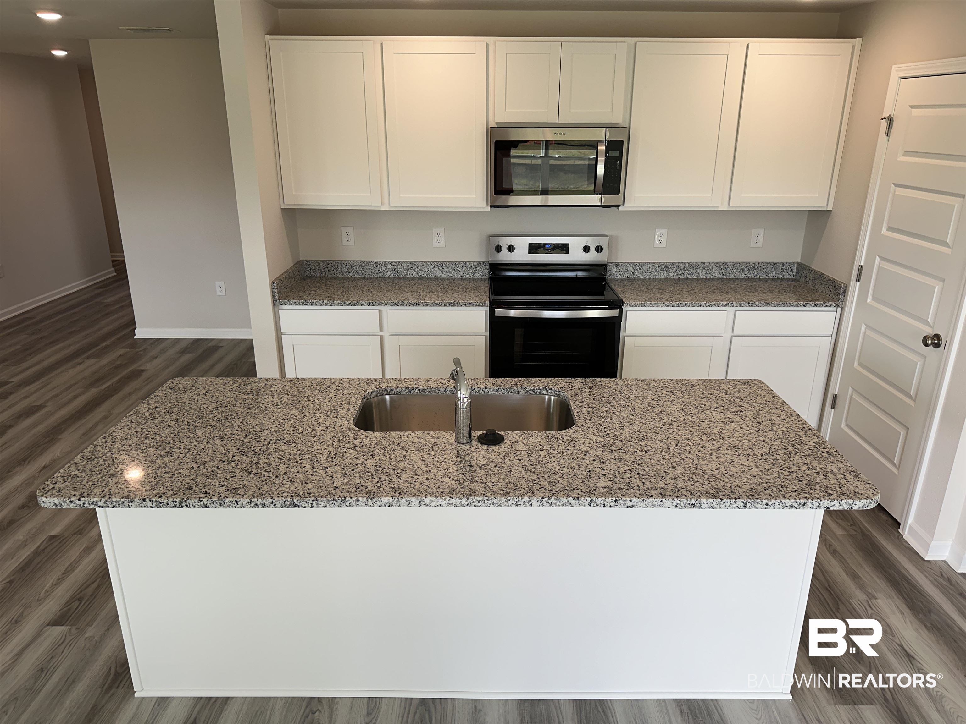 22044 Aleutian Avenue Foley, AL 36535 - Photo 6 of 28 Kitchen featuring appliances with stainless steel finishes, a center island with sink, and white cabinets
