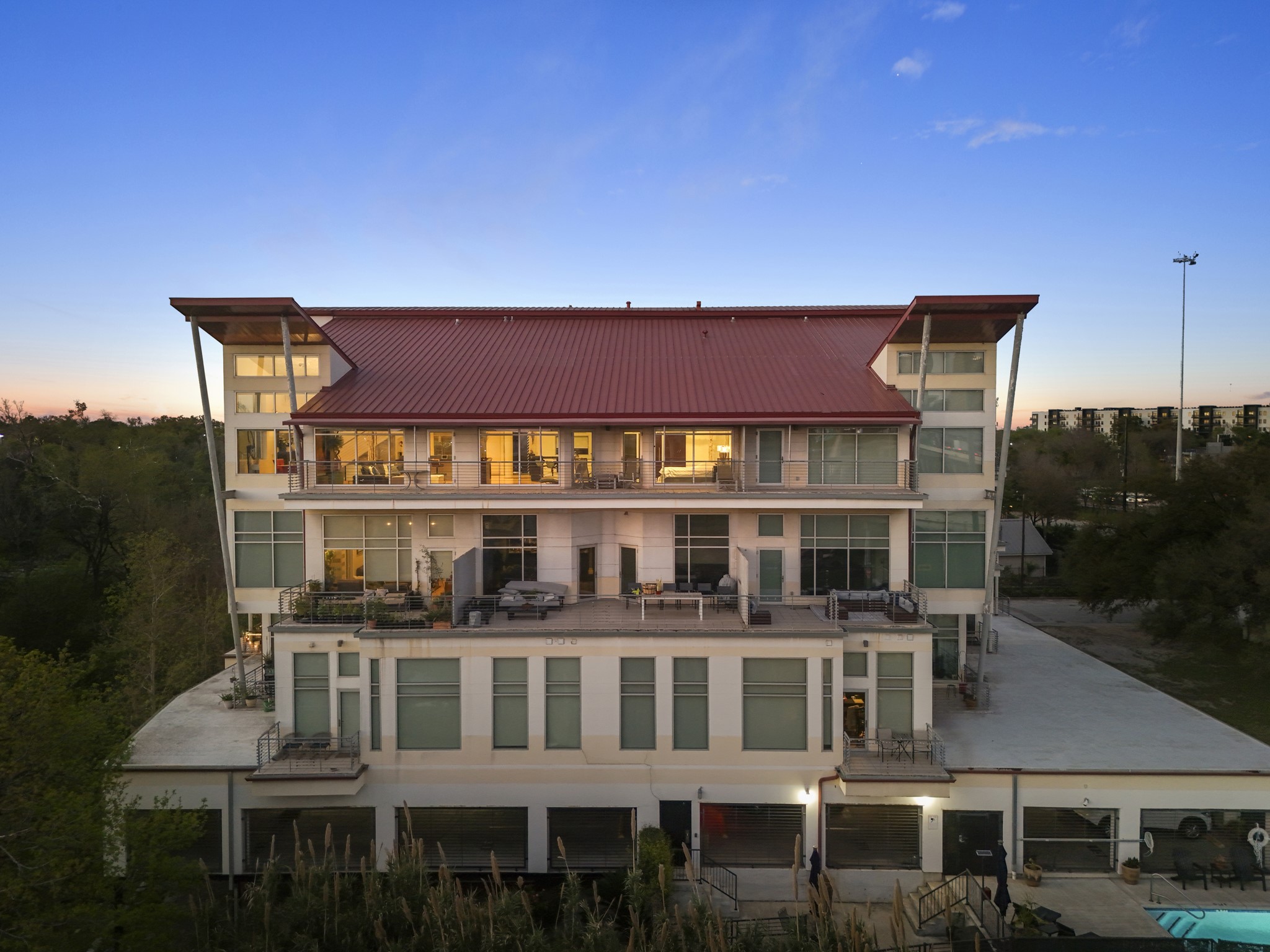 a front view of a residential apartment building with a yard