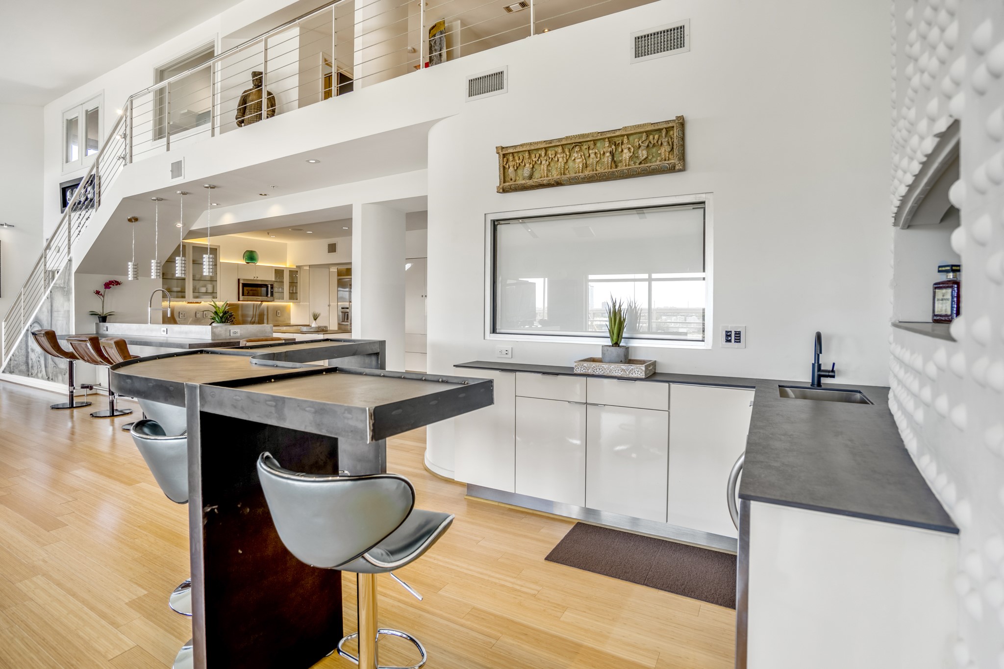 102 Quitman Street, Unit 405 Houston, TX 77009 - Photo 18 of 46 a large living room with granite countertop kitchen island stainless steel appliances a stove a sink and a large window