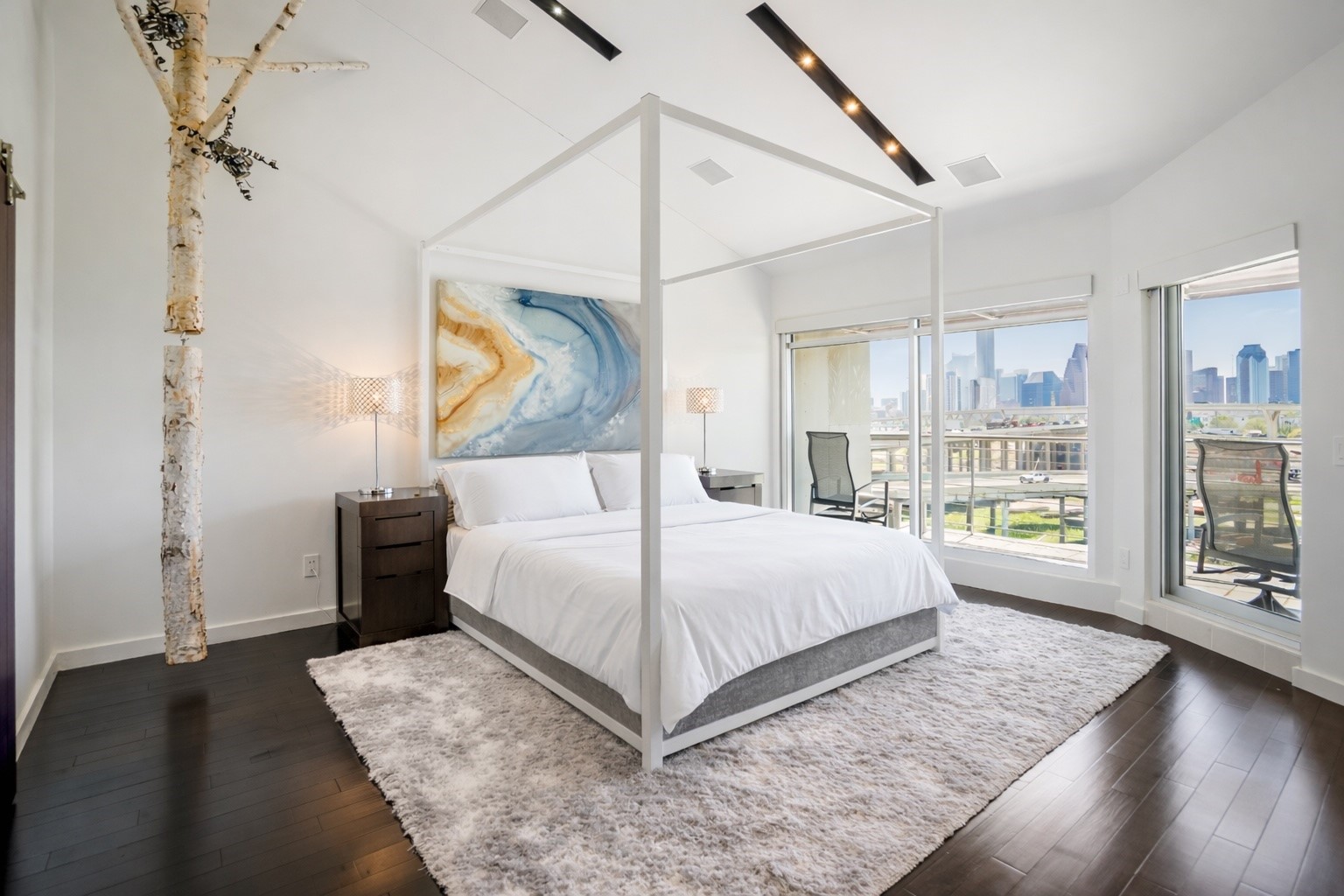 102 Quitman Street, Unit 405 Houston, TX 77009 - Photo 22 of 46 a bedroom with a large bed and a chandelier