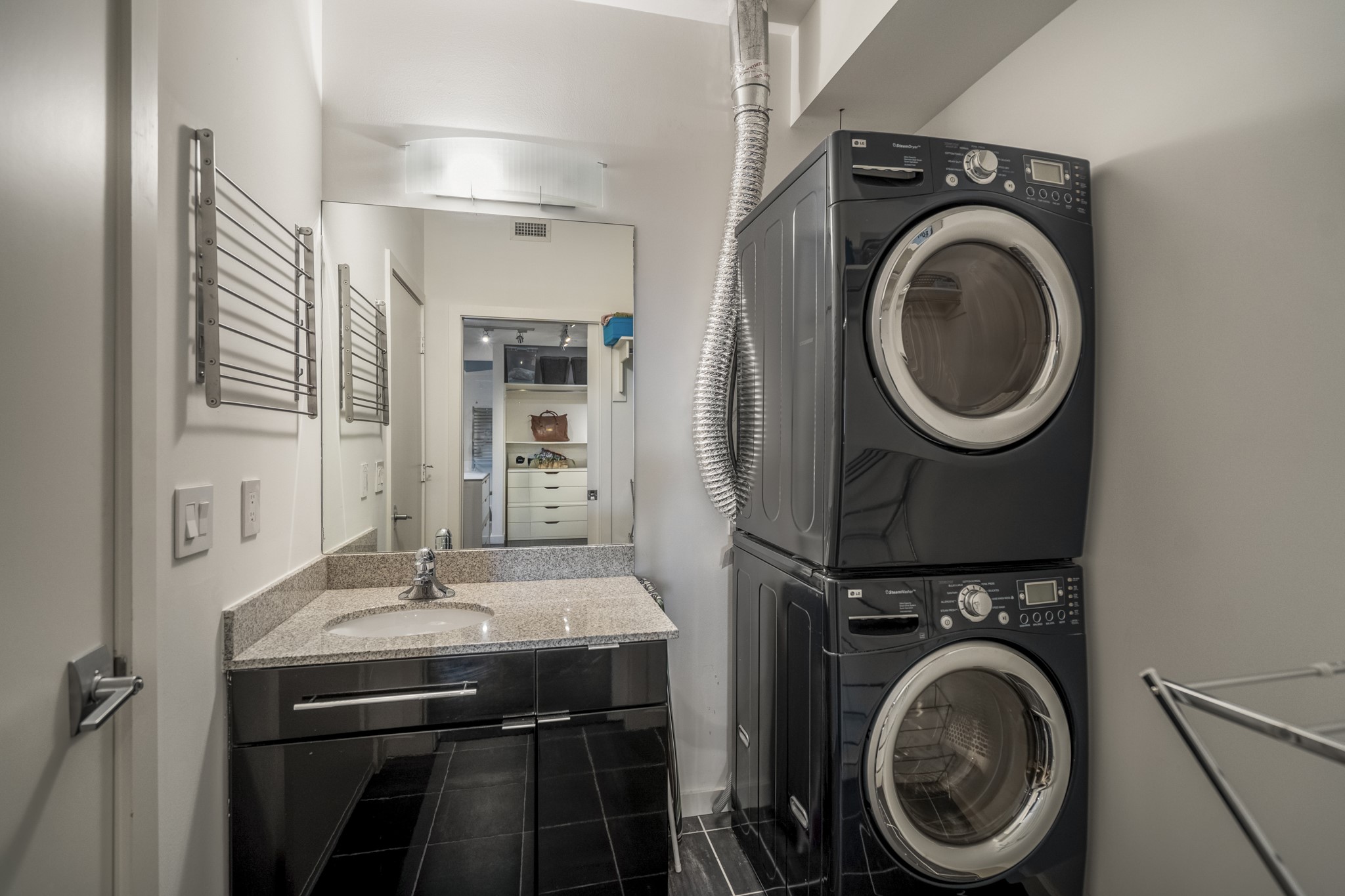 102 Quitman Street, Unit 405 Houston, TX 77009 - Photo 28 of 46 a bathroom with a sink a washer and dryer