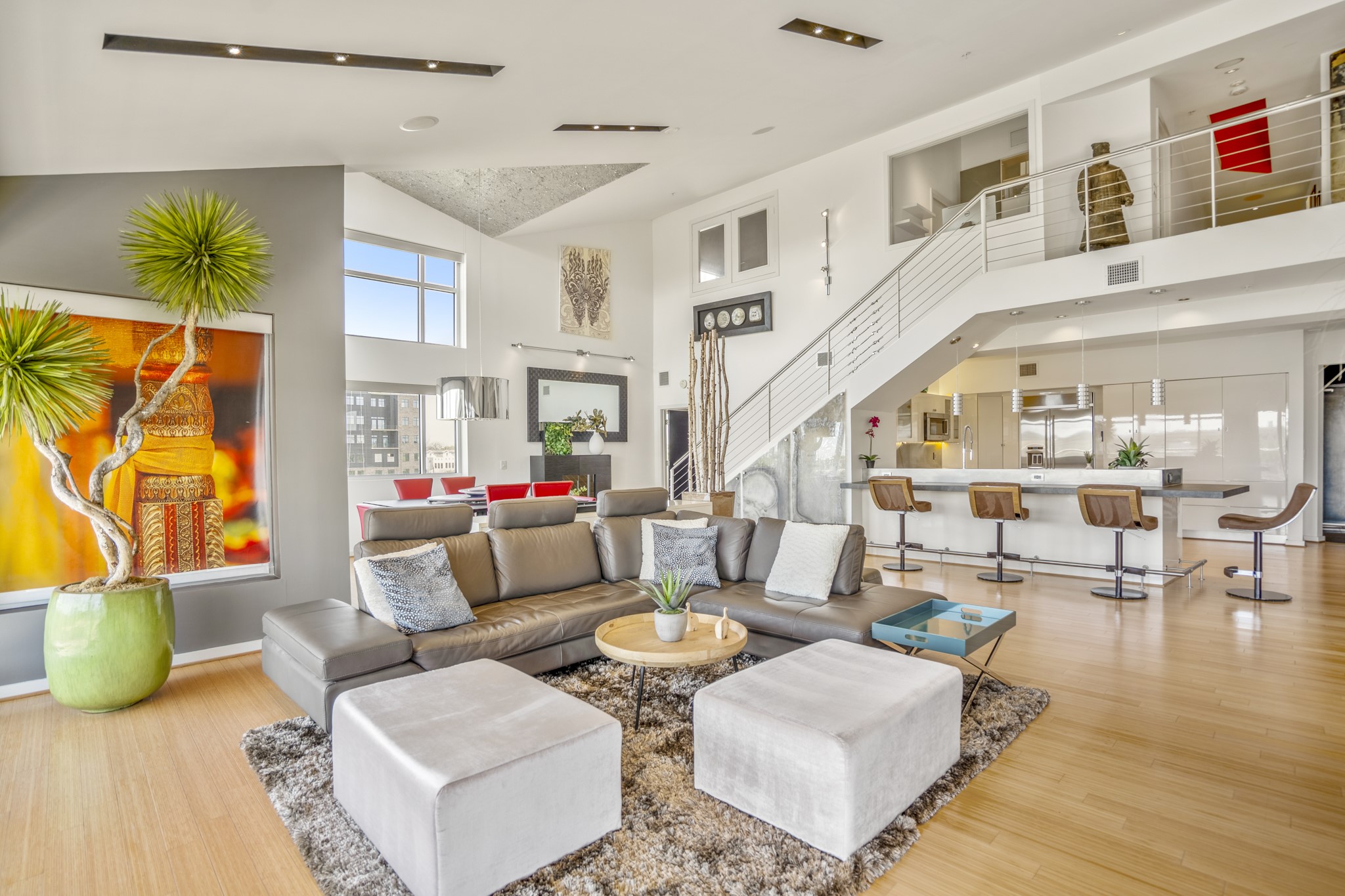 102 Quitman Street, Unit 405 Houston, TX 77009 - Photo 5 of 46 a living room with furniture and a dining table with wooden floor