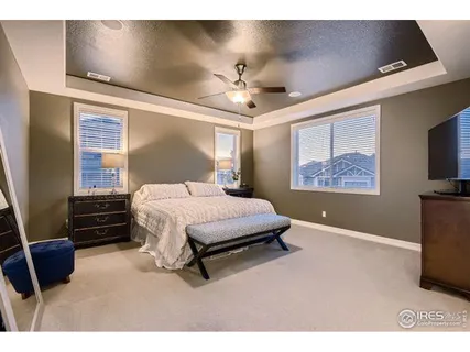 a living room with chairs a table and kitchen view