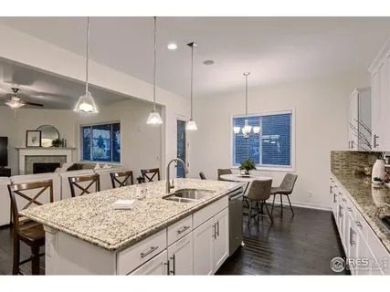 a kitchen with a table chairs refrigerator and microwave