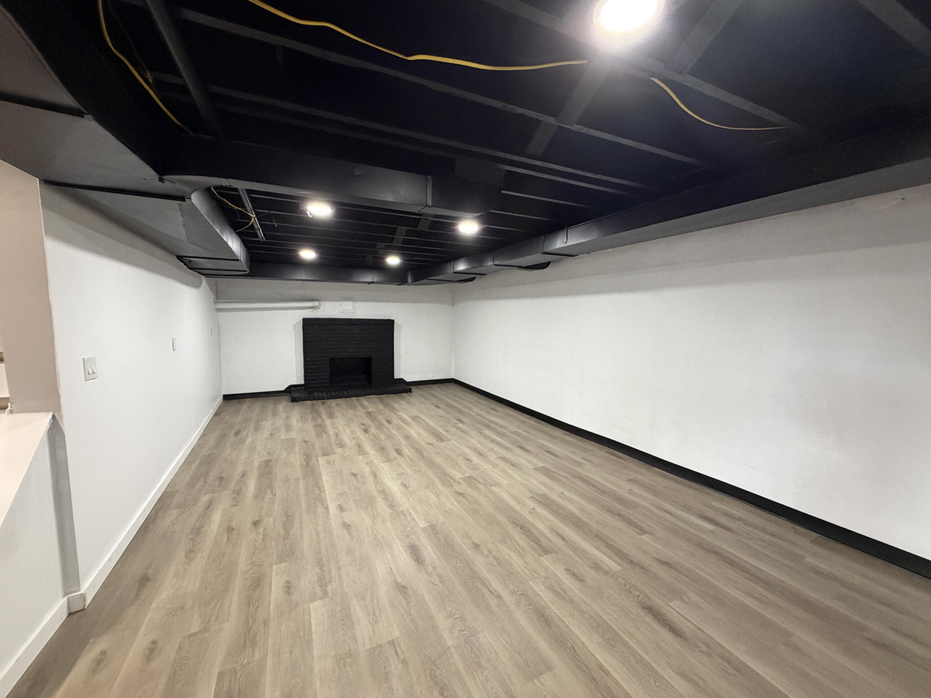 3442 Kershaw Road Northwest Roanoke, VA 24017 - Photo 19 of 29 LVP flooring and fireplace in basement