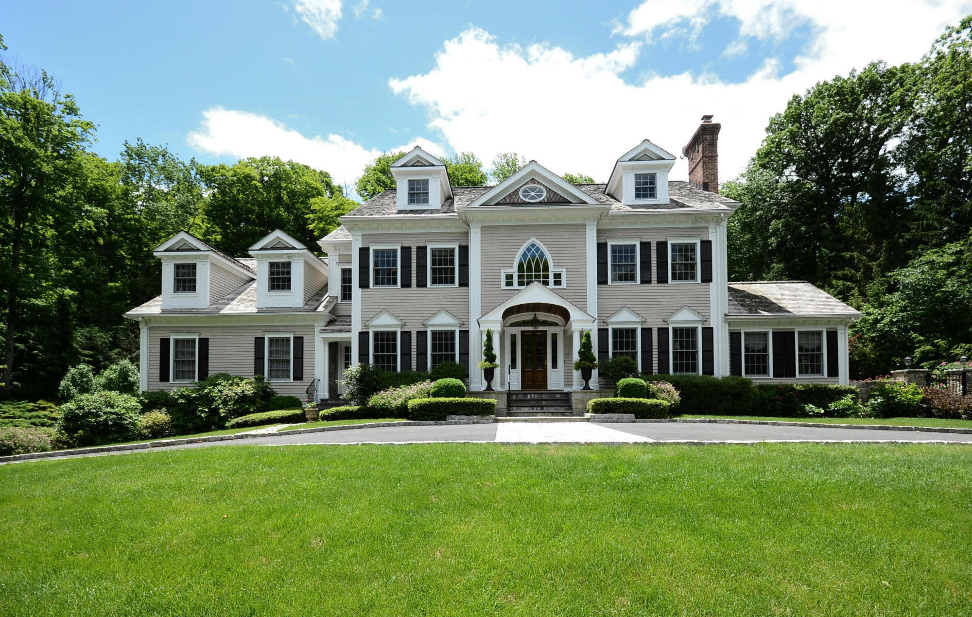 658 Valley Road New Canaan, CT 06840 - Photo 1 of 23 a front view of a house with a yard