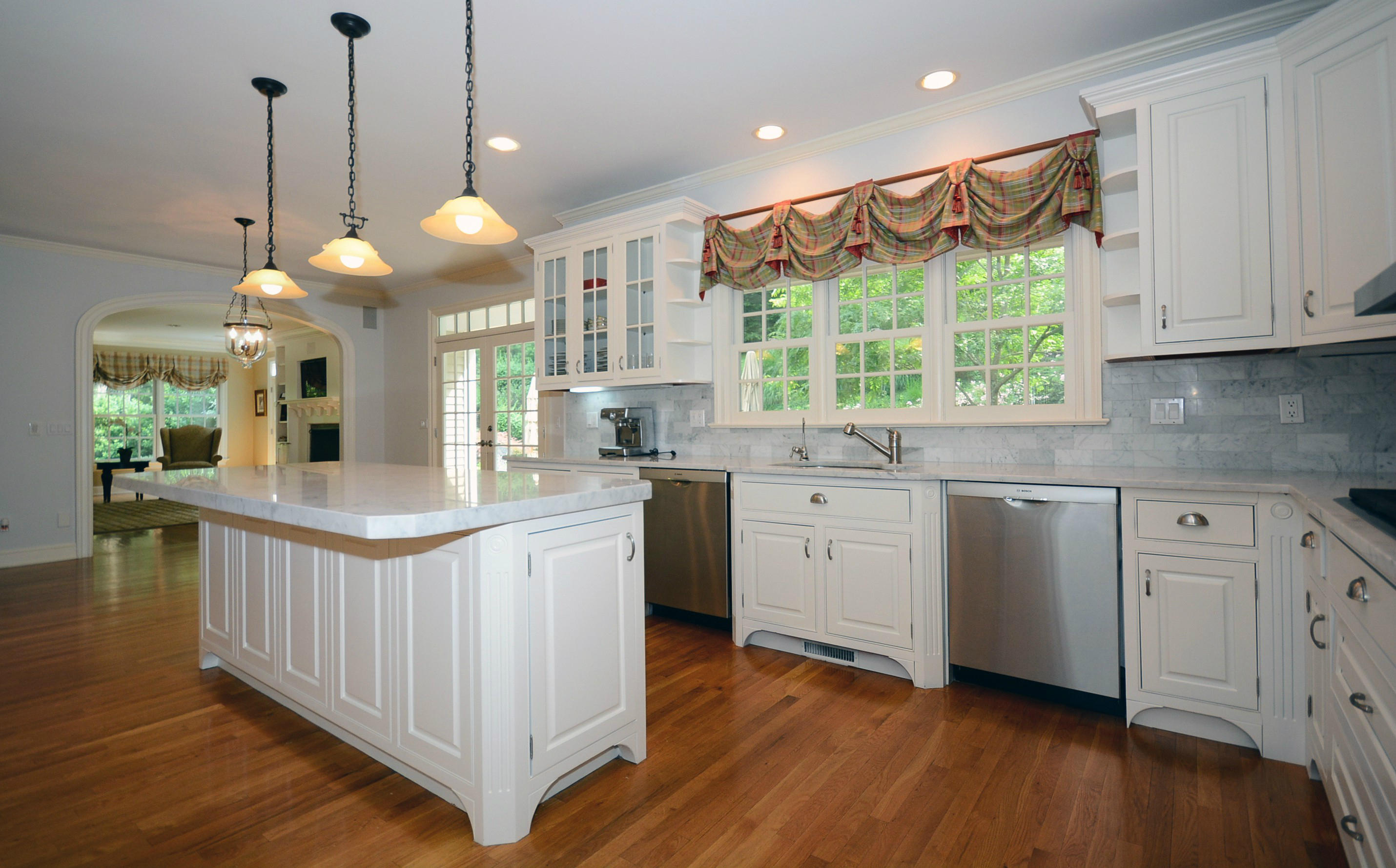 658 Valley Road New Canaan, CT 06840 - Photo 13 of 23 a kitchen that has a lot of cabinets in it and wooden floors