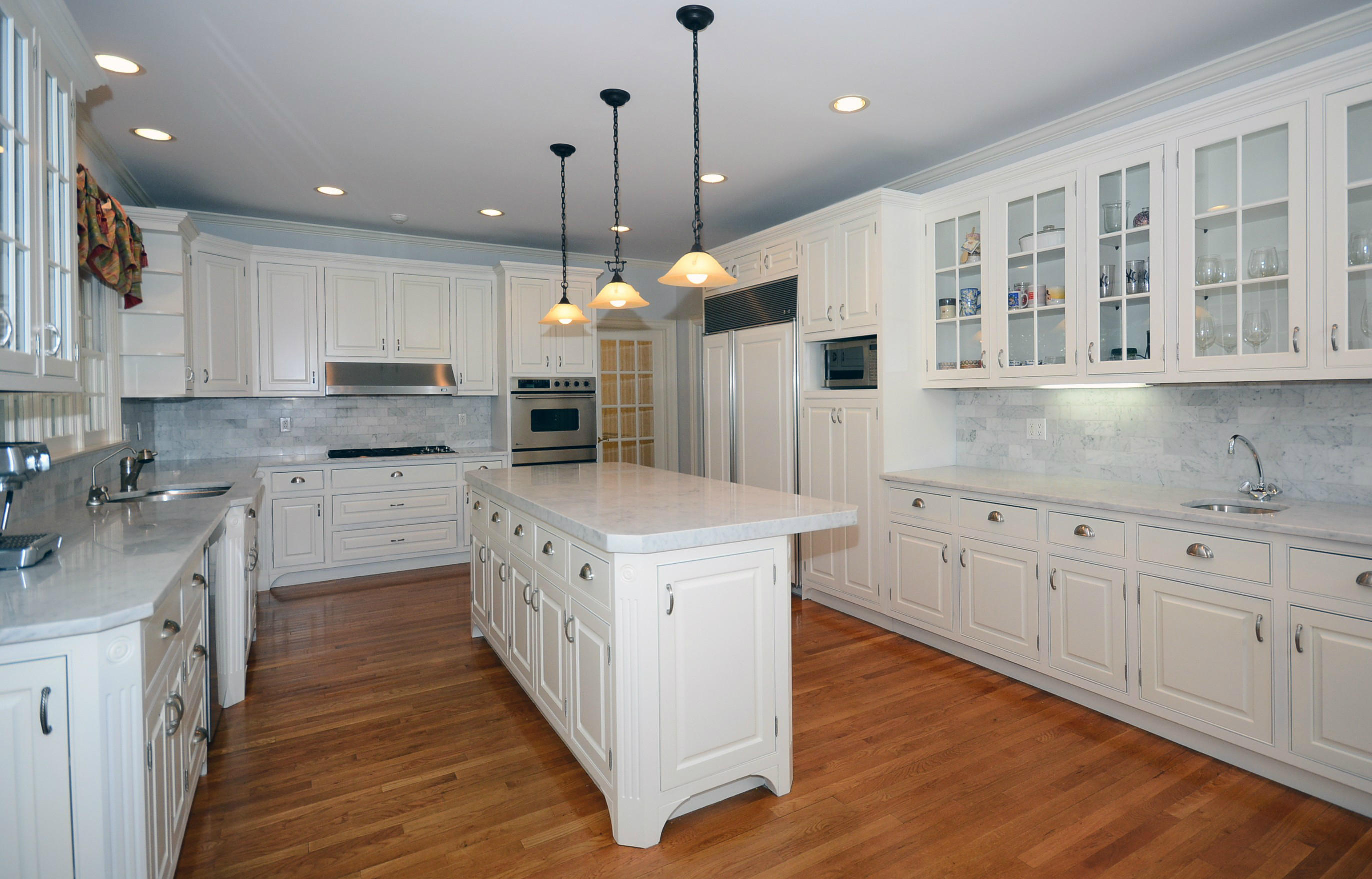 658 Valley Road New Canaan, CT 06840 - Photo 14 of 23 a kitchen with stainless steel appliances kitchen island granite countertop a stove a sink a refrigerator and white cabinets with wooden floor