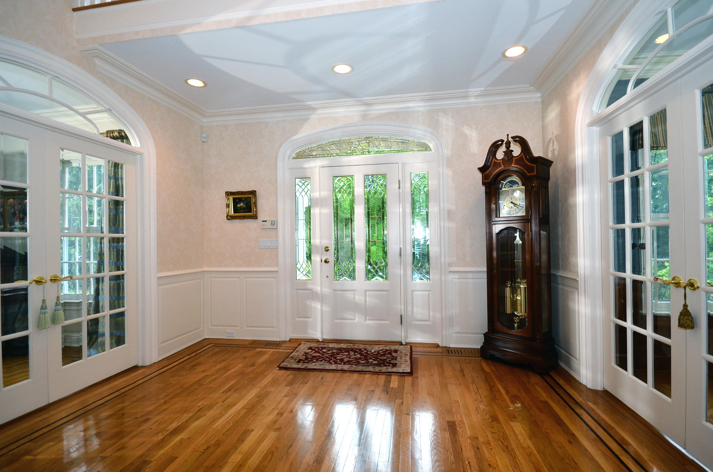 658 Valley Road New Canaan, CT 06840 - Photo 18 of 23 a view of an empty room with glass door and wooden floor