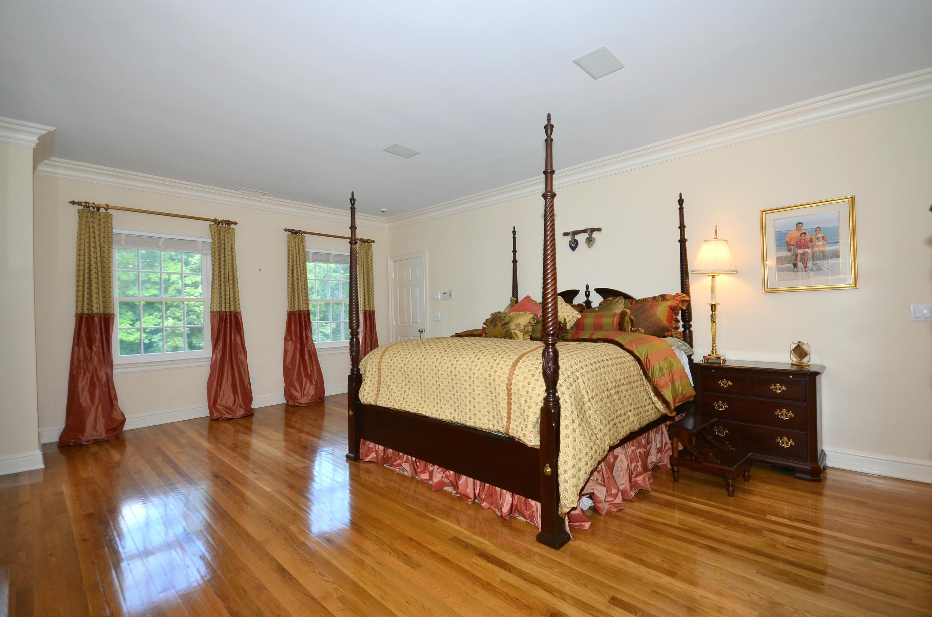 658 Valley Road New Canaan, CT 06840 - Photo 20 of 23 a bedroom with a bed and wooden floor