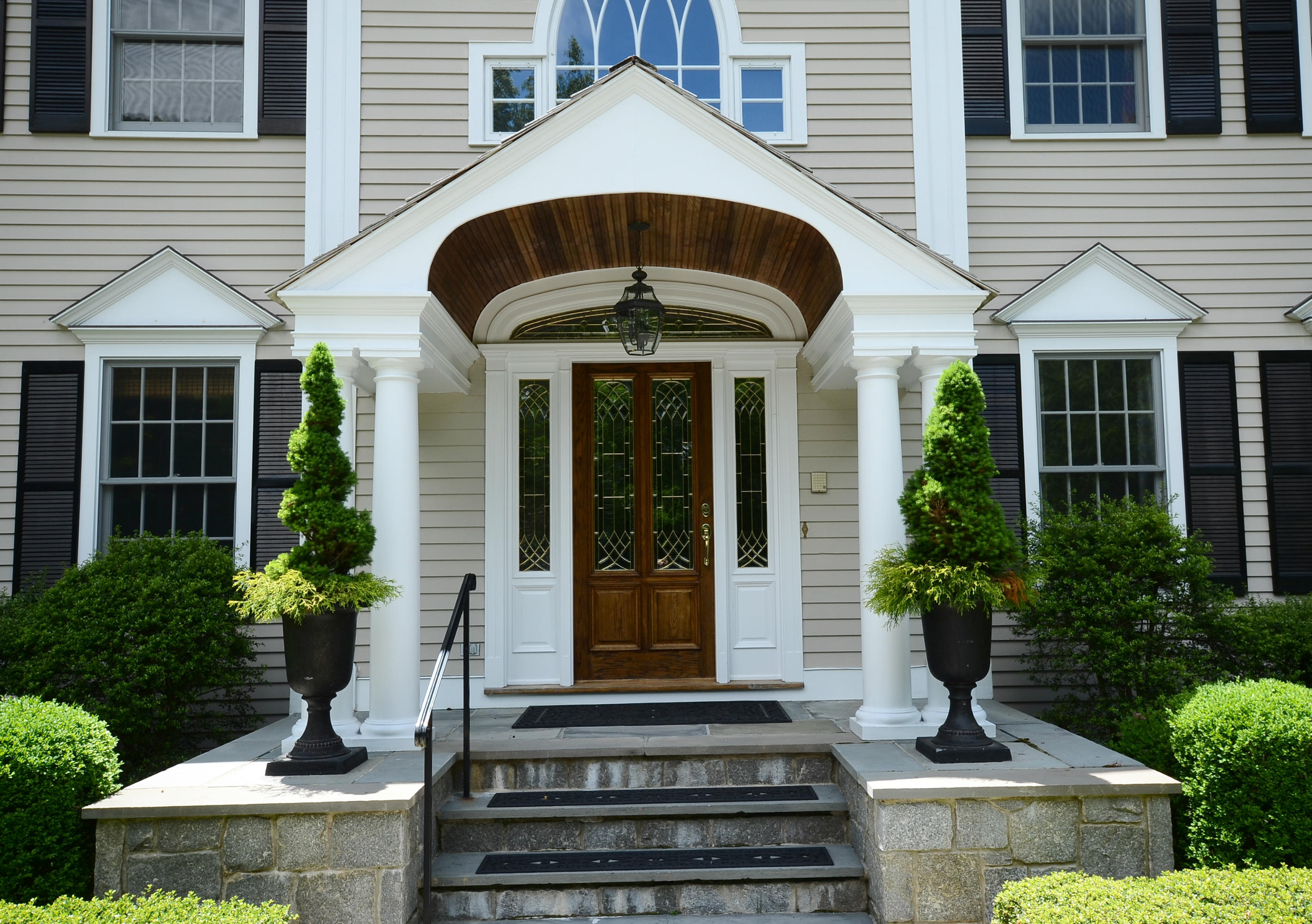 658 Valley Road New Canaan, CT 06840 - Photo 2 of 23 a front view of a house with a yard