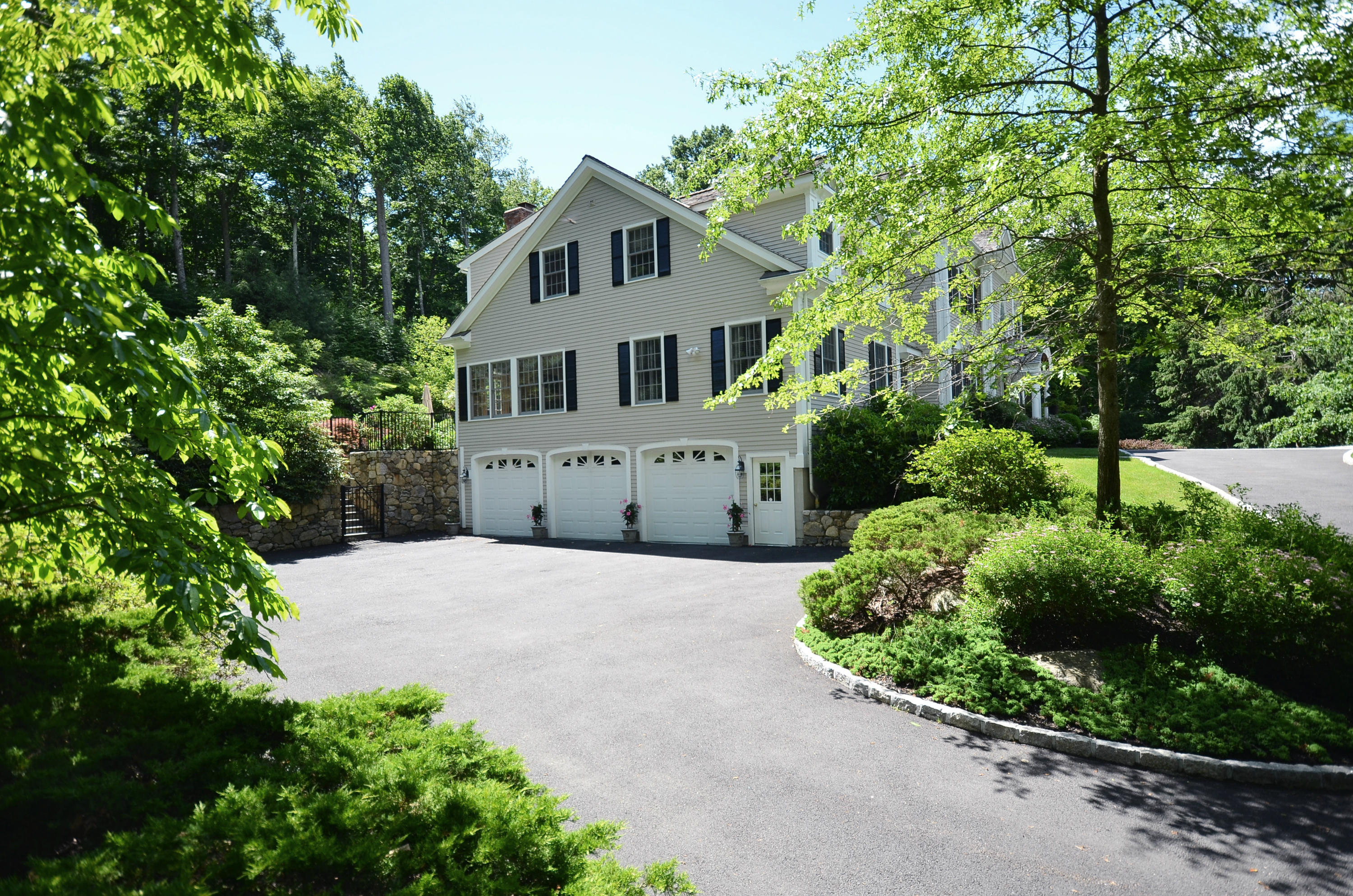 658 Valley Road New Canaan, CT 06840 - Photo 3 of 23 a front view of a house with a yard and potted plants