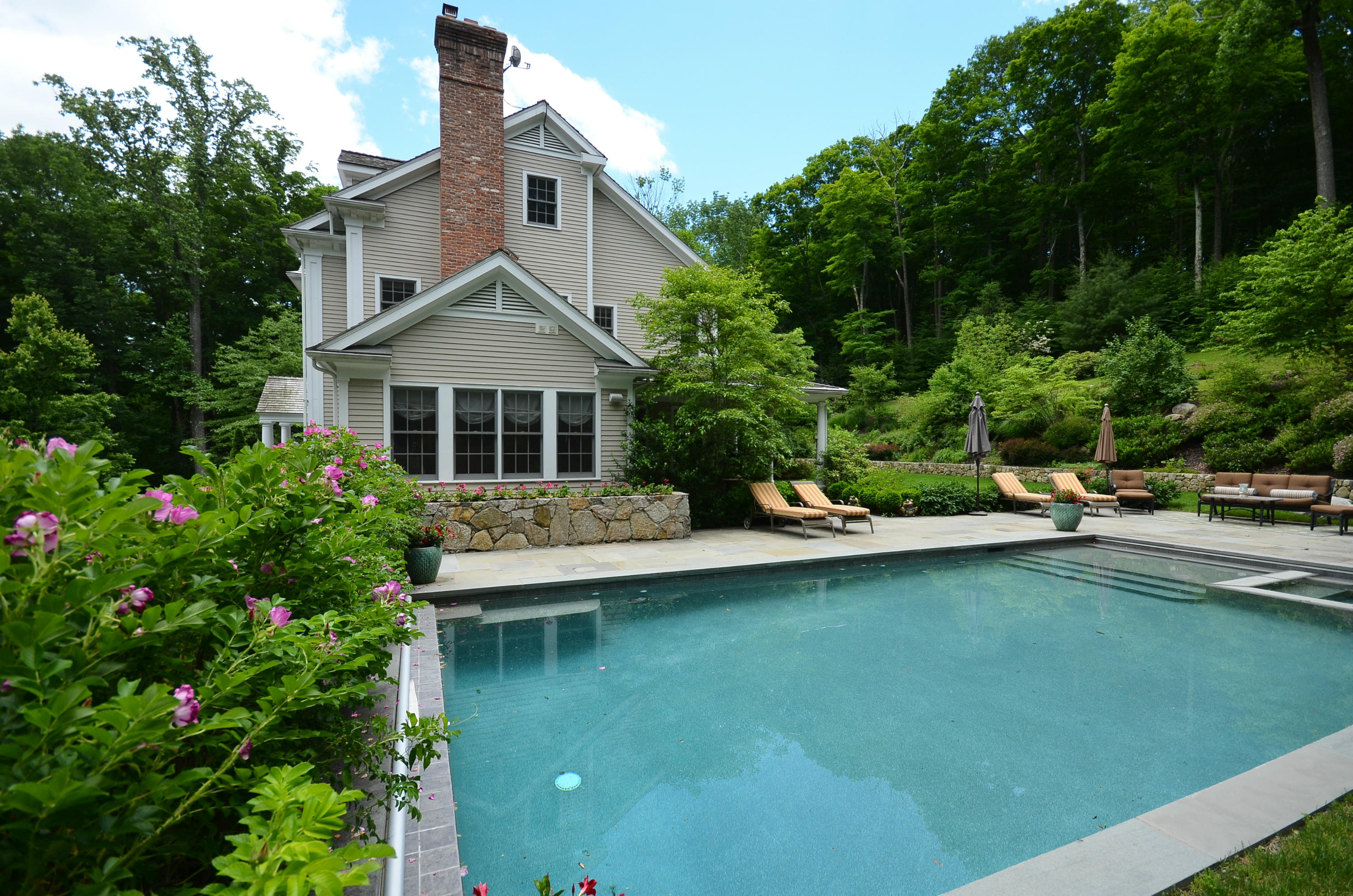 658 Valley Road New Canaan, CT 06840 - Photo 4 of 23 a front view of a house with swimming pool