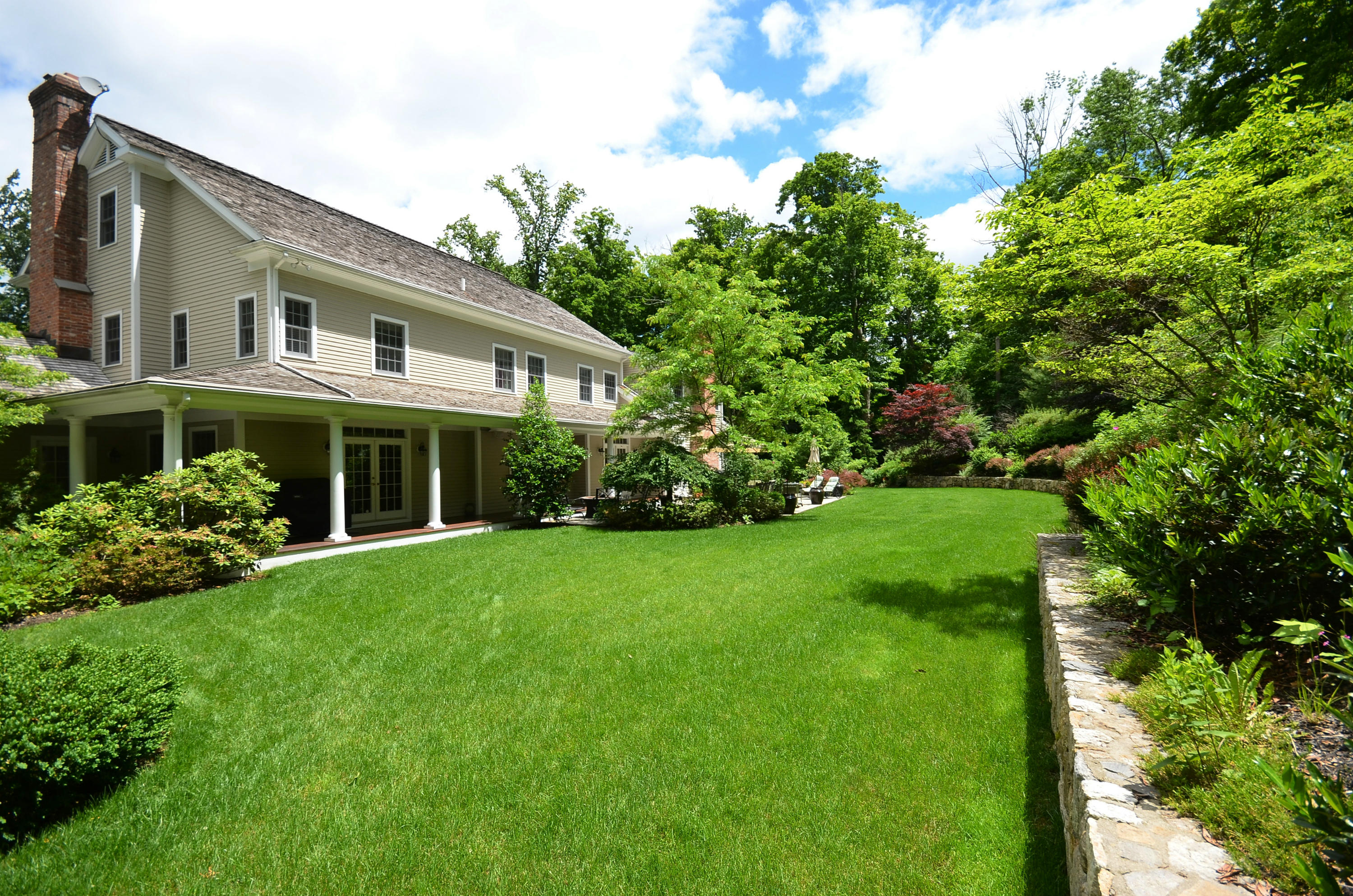 658 Valley Road New Canaan, CT 06840 - Photo 6 of 23 a front view of a house with garden