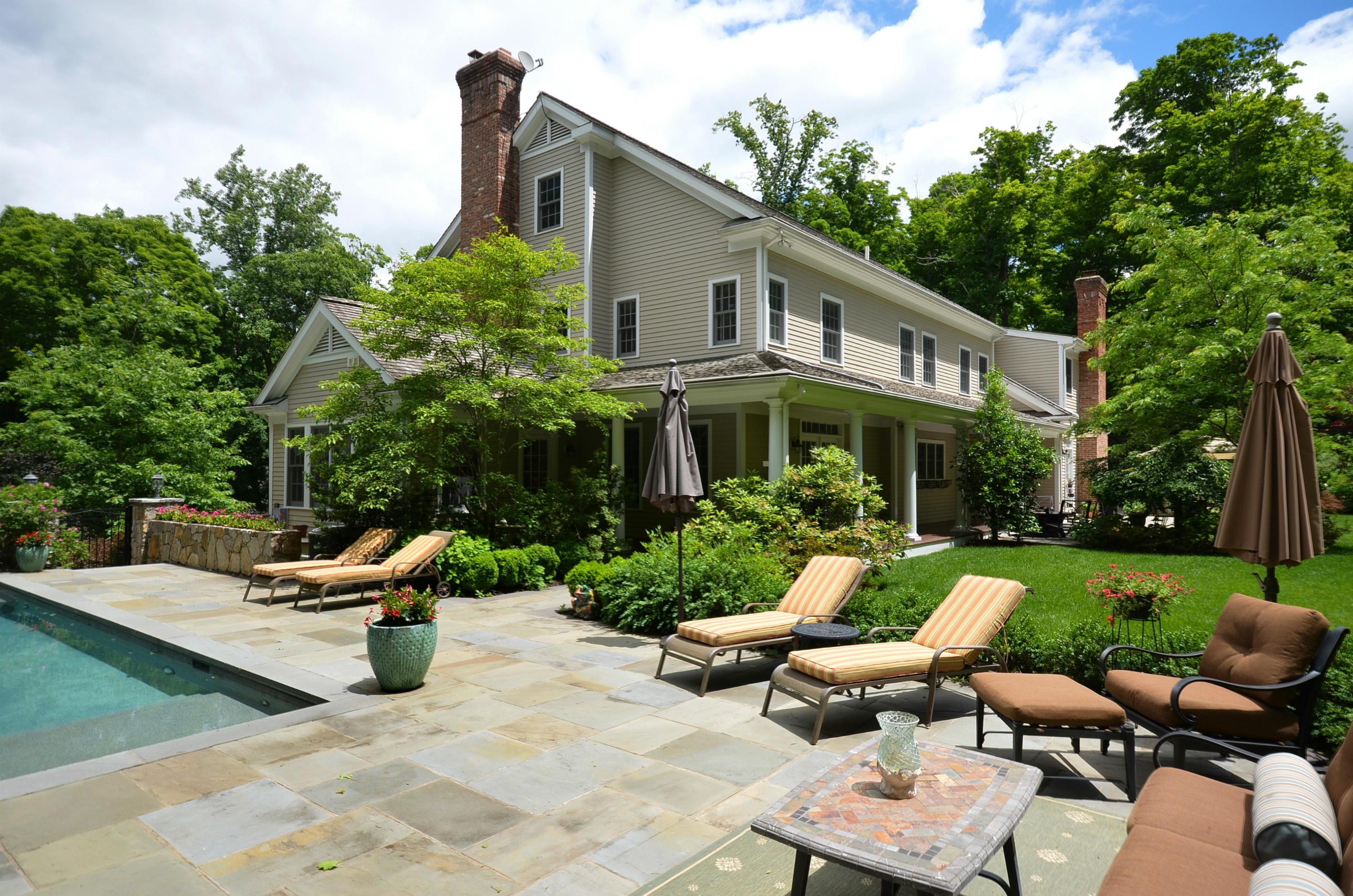 658 Valley Road New Canaan, CT 06840 - Photo 8 of 23 a view of a house with backyard sitting area and garden