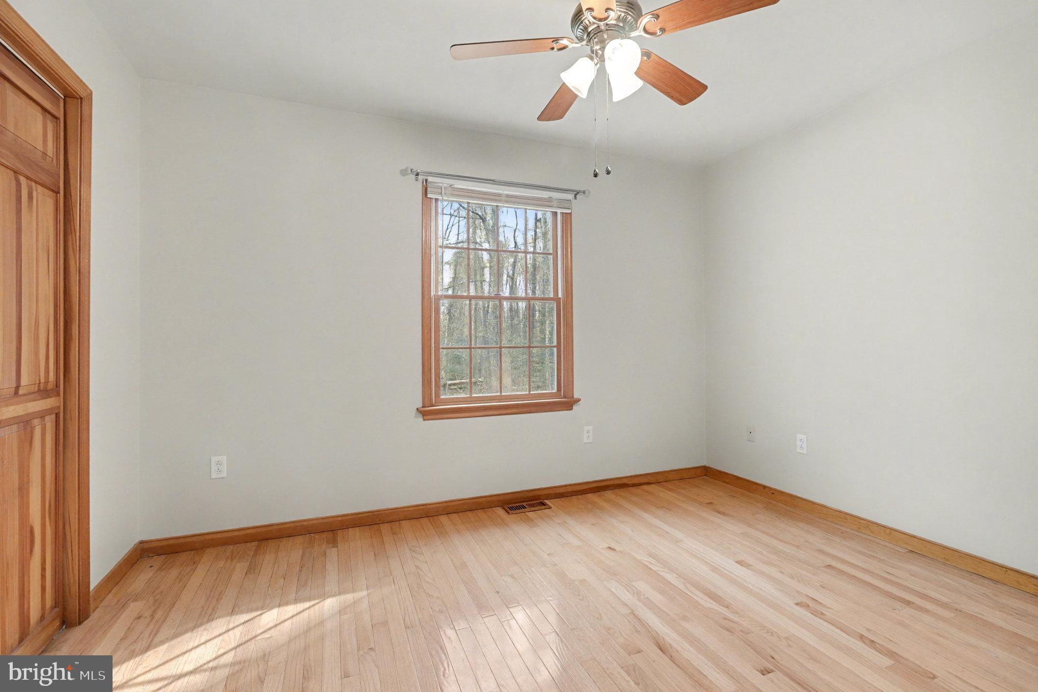 259 Hawkins Farm Road Bumpass, VA 23024 - Photo 14 of 24 a view of an empty room with wooden floor and a window
