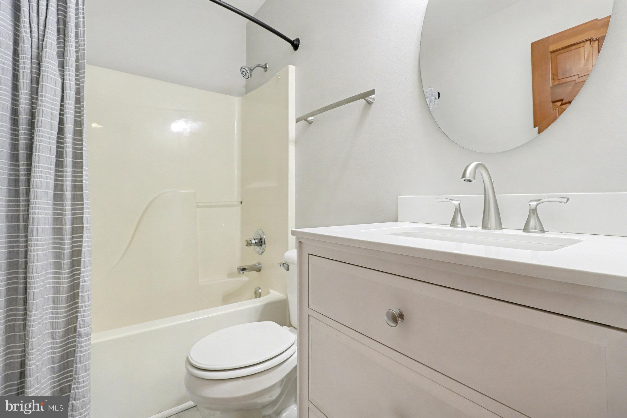 259 Hawkins Farm Road Bumpass, VA 23024 - Photo 15 of 24 a bathroom with a sink a toilet and a mirror