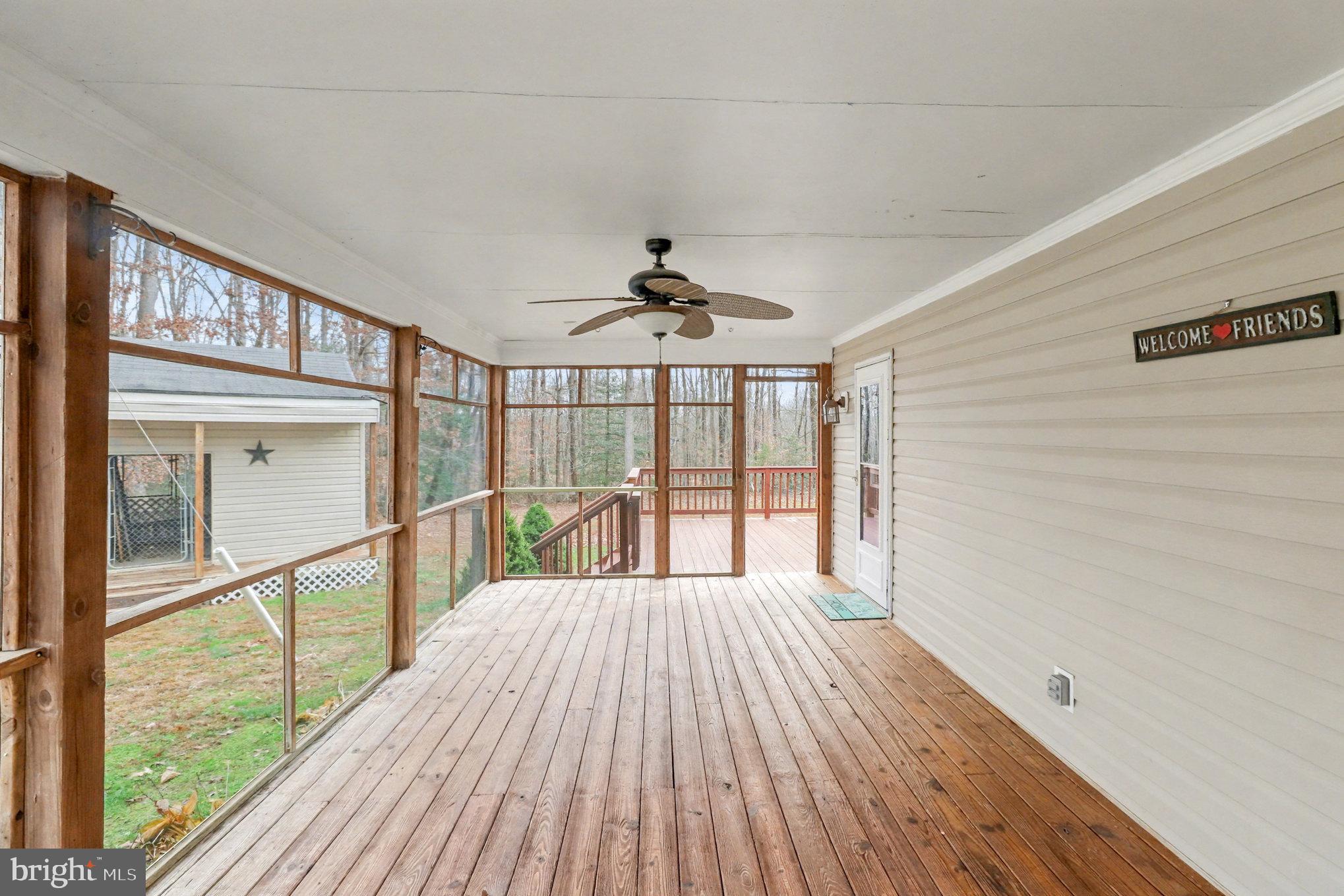 259 Hawkins Farm Road Bumpass, VA 23024 - Photo 17 of 24 a view of a room with wooden floor fan and window