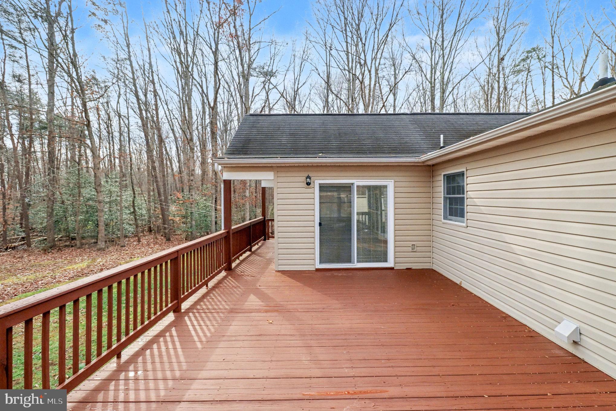 259 Hawkins Farm Road Bumpass, VA 23024 - Photo 18 of 24 a view of backyard with hardwood and deck