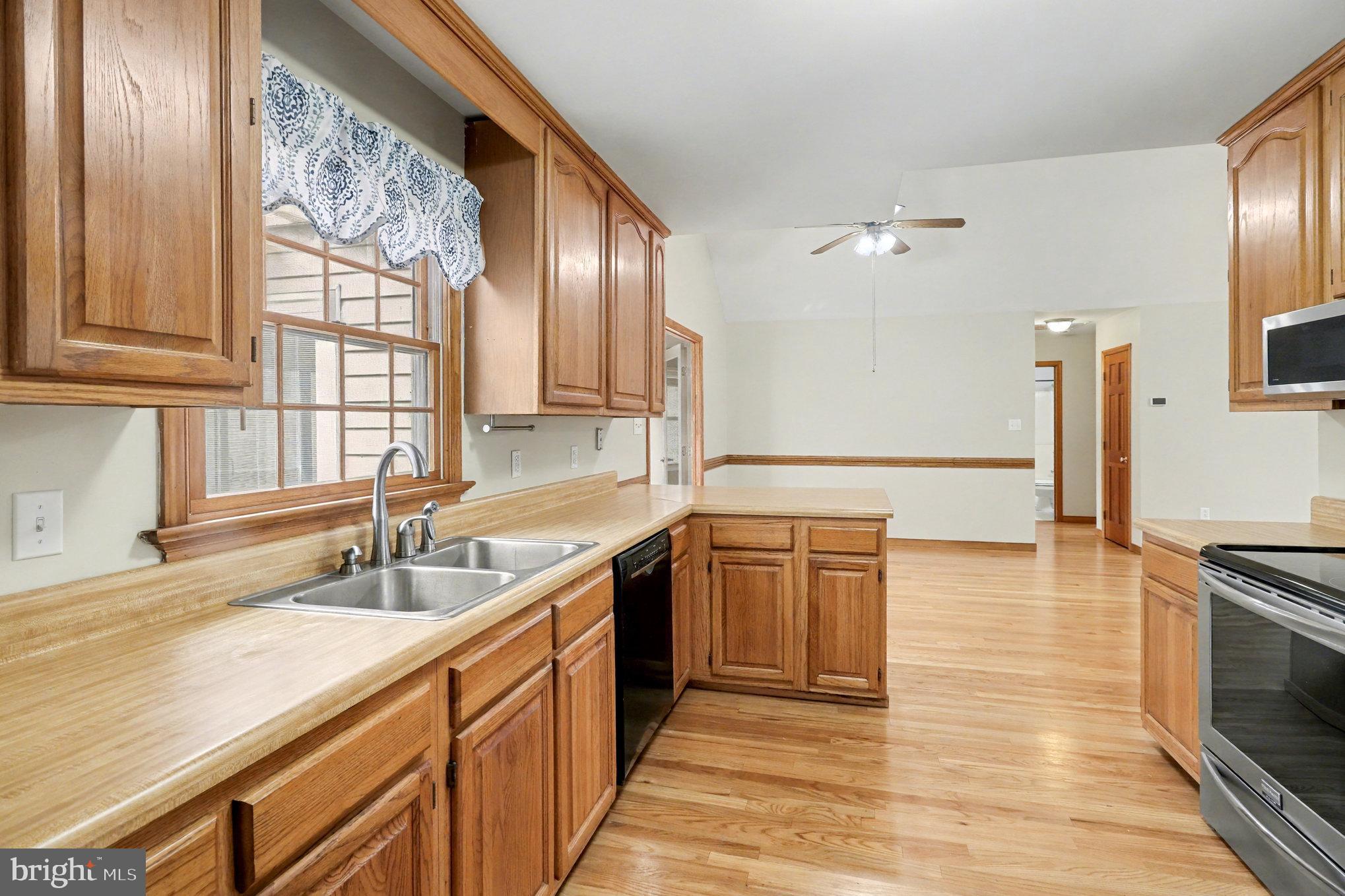 259 Hawkins Farm Road Bumpass, VA 23024 - Photo 8 of 24 a kitchen with stainless steel appliances granite countertop a sink stove and cabinets