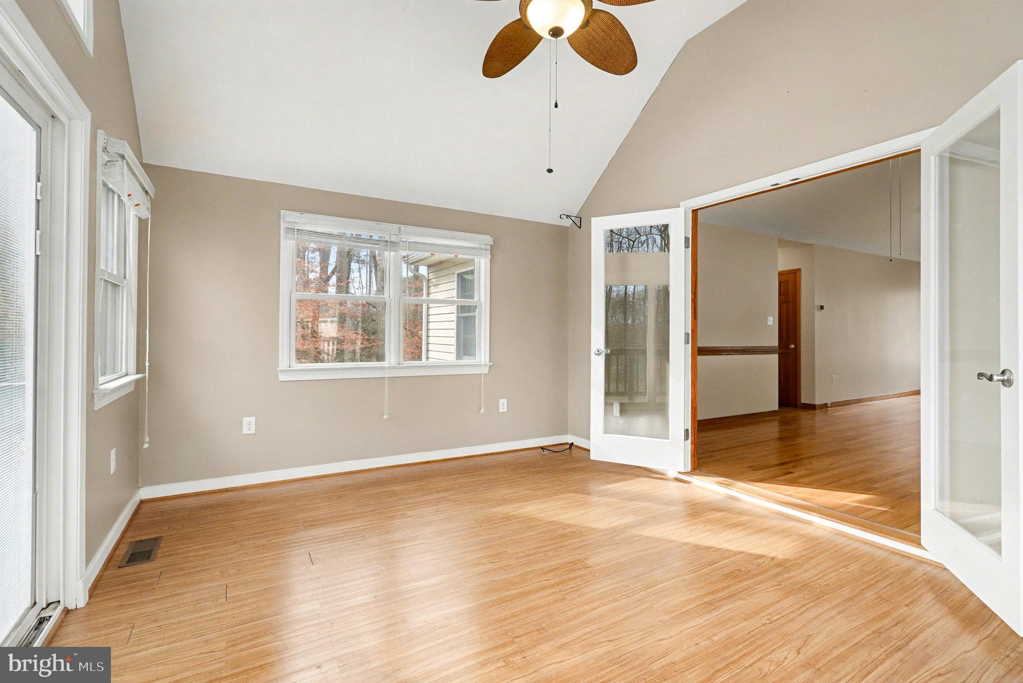 259 Hawkins Farm Road Bumpass, VA 23024 - Photo 9 of 24 a view of an empty room with window and wooden floor