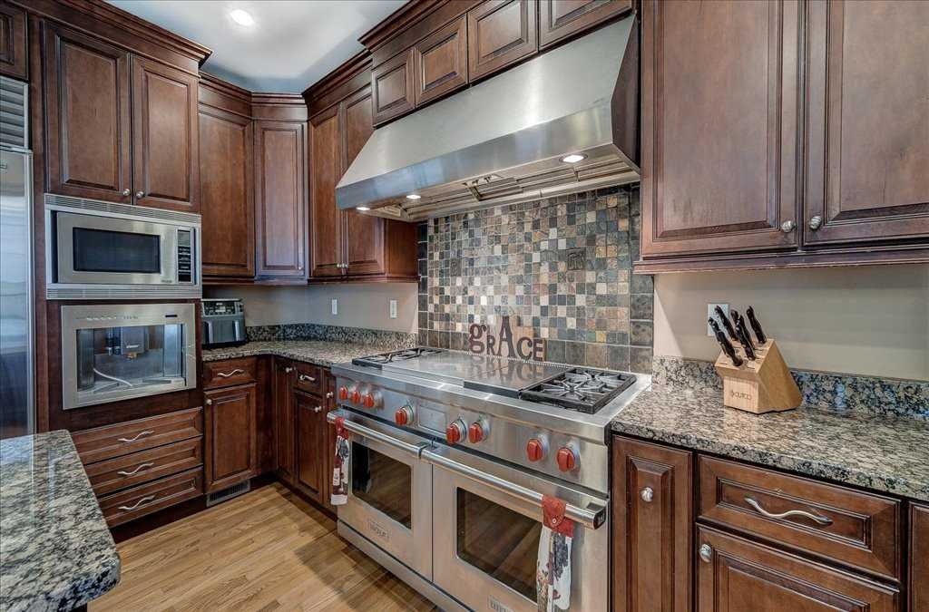 107 Roundhill Road East Fishkill, NY 12533 - Photo 11 of 38 a kitchen with granite countertop a stove top oven microwave and cabinets