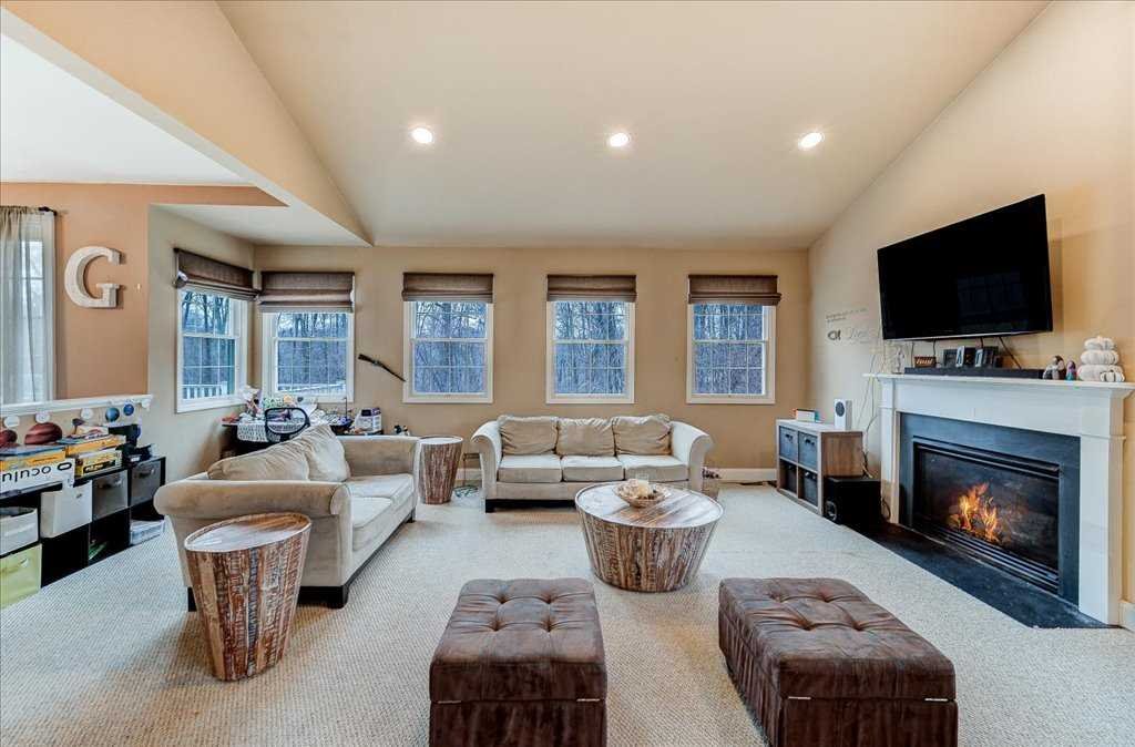 107 Roundhill Road East Fishkill, NY 12533 - Photo 13 of 38 a living room with furniture a fireplace and a flat screen tv