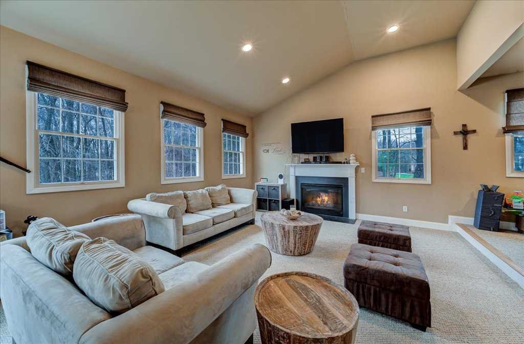 107 Roundhill Road East Fishkill, NY 12533 - Photo 14 of 38 a living room with furniture a fireplace and a flat screen tv