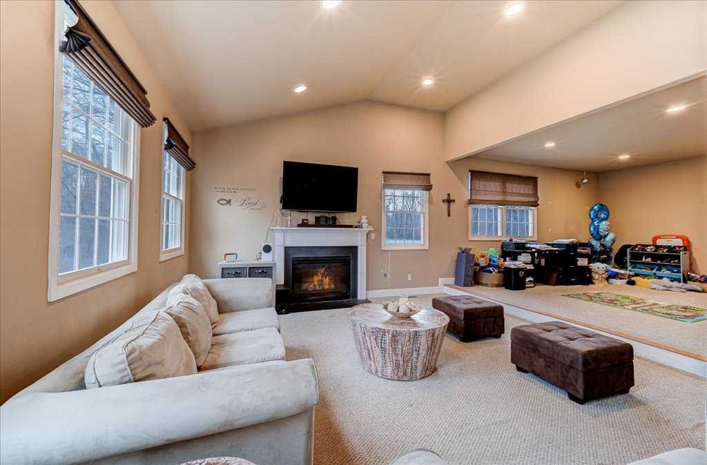 107 Roundhill Road East Fishkill, NY 12533 - Photo 15 of 38 a living room with furniture a fireplace and a flat screen tv