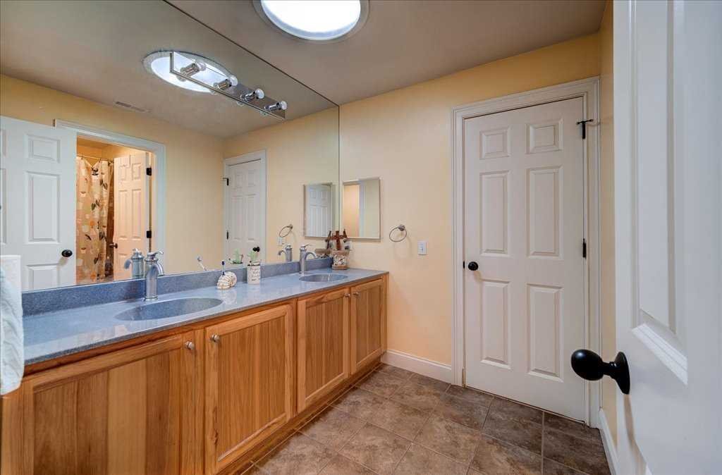 107 Roundhill Road East Fishkill, NY 12533 - Photo 26 of 38 a bathroom with a double vanity sink and a mirror