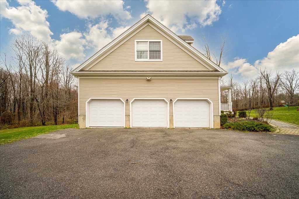 107 Roundhill Road East Fishkill, NY 12533 - Photo 33 of 38 a view of a house with a yard and garage