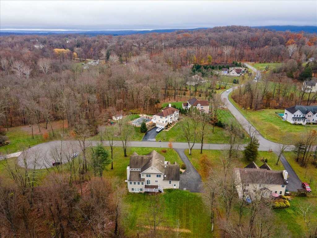107 Roundhill Road East Fishkill, NY 12533 - Photo 36 of 38 an aerial view of a house with a garden and lake view