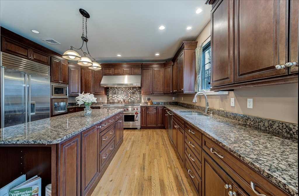 107 Roundhill Road East Fishkill, NY 12533 - Photo 8 of 38 a kitchen with stainless steel appliances granite countertop a sink refrigerator and cabinets