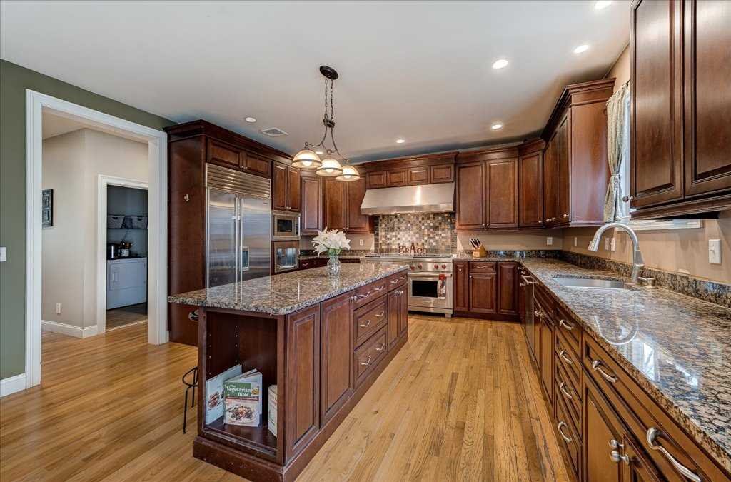 107 Roundhill Road East Fishkill, NY 12533 - Photo 10 of 38 a kitchen with stainless steel appliances granite countertop a sink a stove and a refrigerator
