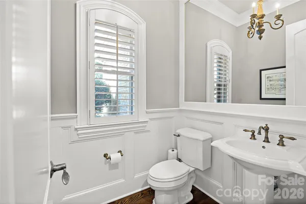 a bathroom with a sink a vanity and a large mirror