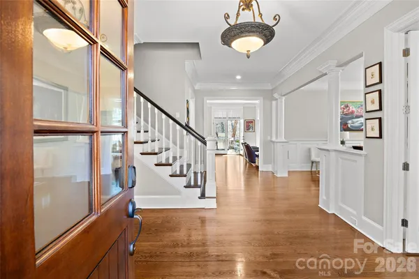 a view of a dining room with furniture wooden floor and a chandelier