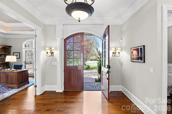 a living room with a fireplace a flat screen tv and a large window