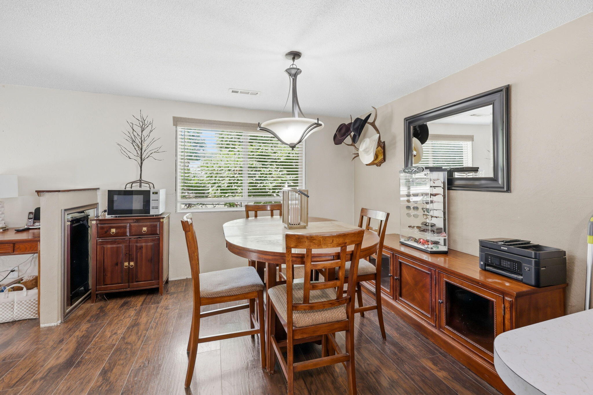 102 Elm Street Phoenix, OR 97535 - Photo 15 of 28 a dining room with wooden floor a chandelier a wooden table and chairs