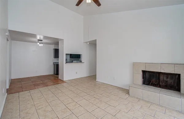 a view of a livingroom with a fireplace and a chandelier