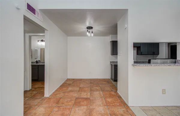 a view of a kitchen from the hallway