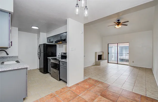 a kitchen with granite countertop a sink stainless steel appliances and cabinets