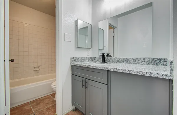 a white bath tub sitting next to a white toilet