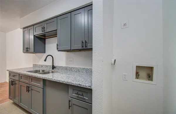 a kitchen with stainless steel appliances granite countertop a sink and cabinets