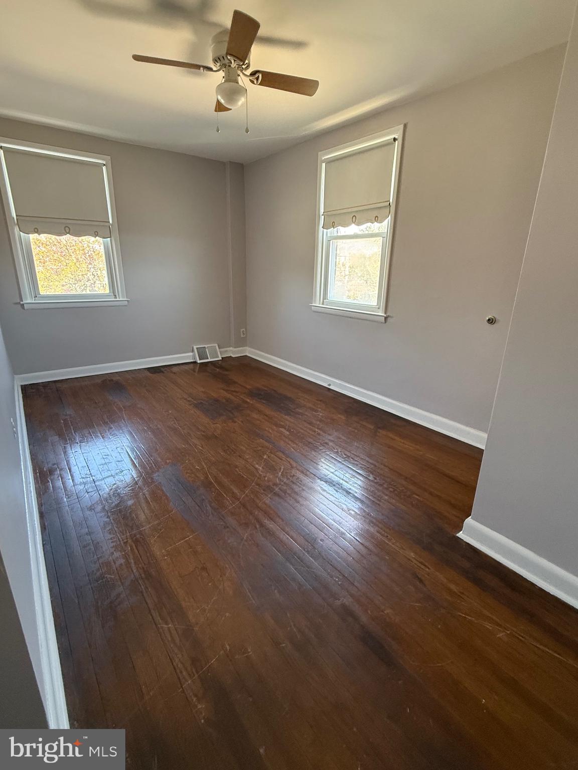 9083 Convent Avenue Philadelphia, PA 19136 - Photo 19 of 22 an empty room with wooden floor and windows