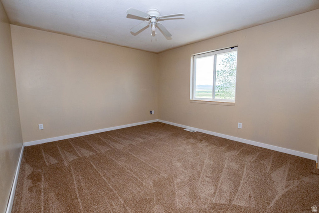 570 West Main Street Beaver, UT 84713 - Photo 17 of 43 Carpeted room featuring a ceiling fan, beige walls, and a window with white trim