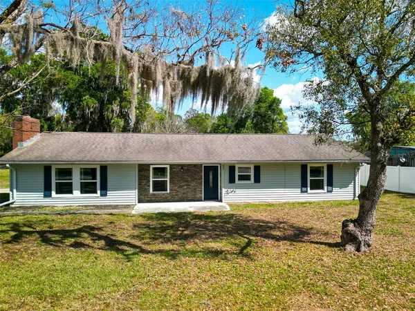 a house that has a tree in front of it