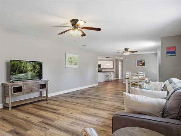 a kitchen with stainless steel appliances white cabinets and wooden floors