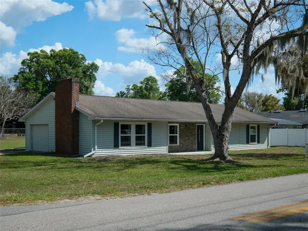 a house that has a tree in front of it